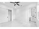 Clean, minimalist bedroom with ensuite bathroom, closet, and marble flooring at 11921 Fort King Hwy, Thonotosassa, FL 33592