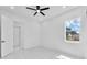 Bright bedroom with modern ceiling fan, sleek marble floors, and a sunlit window at 11921 Fort King Hwy, Thonotosassa, FL 33592