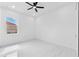 Minimalist bedroom with sleek ceiling fan, a window view, and light marble flooring at 11921 Fort King Hwy, Thonotosassa, FL 33592