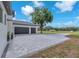 Paver driveway leads to a two-car garage, surrounded by well-maintained landscaping at 11921 Fort King Hwy, Thonotosassa, FL 33592