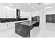 Bright kitchen featuring white cabinets, black marble countertops, a center island, and stainless steel appliances at 11921 Fort King Hwy, Thonotosassa, FL 33592