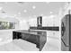 Contemporary kitchen with stainless steel appliances, a black marble island, and ample cabinet space at 11921 Fort King Hwy, Thonotosassa, FL 33592