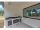 Modern outdoor kitchen with sleek cabinets and sink, perfect for entertaining at 11921 Fort King Hwy, Thonotosassa, FL 33592