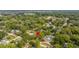 Aerial view of the property nestled among lush trees in a residential area at 1216 E Lambright St, Tampa, FL 33604