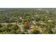 Expansive aerial view of a neighborhood with mature trees and single-Gathering homes, some with pools at 1216 E Lambright St, Tampa, FL 33604