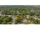 An aerial view of the neighborhood with houses, streets, and tree coverage at 1216 E Lambright St, Tampa, FL 33604