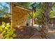 This backyard features a rock climbing wall surrounded by tropical landscaping at 1216 E Lambright St, Tampa, FL 33604