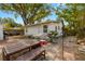 View of the home's exterior showing the back patio area with a table and bench at 1216 E Lambright St, Tampa, FL 33604