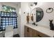Well-lit bathroom features a decorative mirror, vanity with drawers, a sink and toilet at 1216 E Lambright St, Tampa, FL 33604