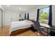 Bright bedroom featuring a large window, wood floors, and a modern aesthetic at 1216 E Lambright St, Tampa, FL 33604