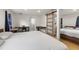 Bright bedroom with a sliding barn door, and two work areas with desks and bright natural lighting at 1216 E Lambright St, Tampa, FL 33604