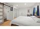 Brightly lit bedroom with wood flooring and natural light features a large closet and two doors at 1216 E Lambright St, Tampa, FL 33604