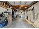 Spacious cluttered garage with a laundry machines, storage and lighting, ready for organization at 1216 E Lambright St, Tampa, FL 33604