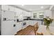 Charming kitchen with white cabinets, laminate countertops and wood grain flooring at 1216 E Lambright St, Tampa, FL 33604