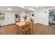 Open-concept kitchen featuring wood flooring, white walls and a view to the bathroom at 1216 E Lambright St, Tampa, FL 33604