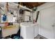 A utilitarian laundry area with a deep sink and shelving for cleaning supplies, plus a modern machine set at 1216 E Lambright St, Tampa, FL 33604