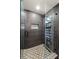 Modern shower stall with glass enclosure and gray tiling, plus geometric tiles on the floor at 1216 E Lambright St, Tampa, FL 33604