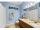 Bright bathroom with double sinks, dark wood vanity, granite countertops, and nautical decor at 1271 Drew St, Clearwater, FL 33755