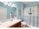 Inviting bathroom featuring blue walls, dark wood vanity, neutral countertop, and nautical-themed decor at 1271 Drew St, Clearwater, FL 33755