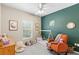 Adorable bedroom with a tent frame bed, an orange rocking chair, and natural light from a window at 1271 Drew St, Clearwater, FL 33755