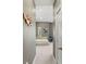 Hallway leading to a bedroom featuring neutral walls, plush carpet, and a decorative wooden wall art at 1271 Drew St, Clearwater, FL 33755