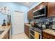 Modern kitchen featuring stainless steel appliances, granite countertops, and blue backsplash at 1271 Drew St, Clearwater, FL 33755