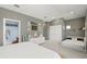Large bedroom features neutral walls, carpet, a decorative dresser, and a bathroom entrance at 1271 Drew St, Clearwater, FL 33755