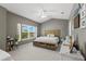 Spacious bedroom featuring large window, sloped ceilings, neutral walls, and coastal decor at 1271 Drew St, Clearwater, FL 33755