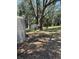 Scenic backyard with a metal shed, beautiful trees, and plenty of space at 12720 Jan St, San Antonio, FL 33576