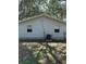 A simple vinyl-sided home with a small central air conditioning unit at 12720 Jan St, San Antonio, FL 33576