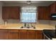 Well-lit kitchen with stainless steel sink and ample cabinet space for storage and organization at 12720 Jan St, San Antonio, FL 33576