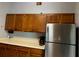 Kitchen featuring stainless steel refrigerator, light countertops, and wood cabinets at 12720 Jan St, San Antonio, FL 33576
