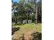 Outdoor shed on a grassy lot, surrounded by mature trees at 12720 Jan St, San Antonio, FL 33576