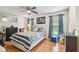 Bright bedroom featuring a ceiling fan, wood flooring, and natural light from the window at 1304 Cedar Ct, Tarpon Springs, FL 34689