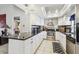 Modern kitchen with stainless steel appliances, white cabinetry, and granite countertops at 1304 Cedar Ct, Tarpon Springs, FL 34689