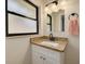 Bathroom vanity features granite countertop and bronze fixtures at 1322 Byron Dr, Clearwater, FL 33756