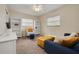Well-lit bedroom with accent furniture, shelves, and plush seating at 1322 Byron Dr, Clearwater, FL 33756
