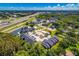 An aerial view of a well-maintained apartment complex with parking, landscaping and nearby highway and lake at 1400 Gandy N Blvd # 1705, St Petersburg, FL 33702