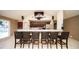 Bar area featuring bar stools, a countertop, and a view of the community pool through a large window at 1400 Gandy N Blvd # 1705, St Petersburg, FL 33702