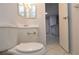 Standard bathroom featuring a toilet, single-sink vanity, and view into an open doorway at 1400 Gandy N Blvd # 1705, St Petersburg, FL 33702