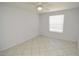 Empty bedroom with tile flooring, ceiling fan, and window at 1400 Gandy N Blvd # 1705, St Petersburg, FL 33702