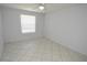 Empty bedroom featuring tile flooring, a ceiling fan, and a window at 1400 Gandy N Blvd # 1705, St Petersburg, FL 33702