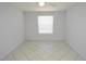 Empty bedroom with tile flooring, ceiling fan, and window at 1400 Gandy N Blvd # 1705, St Petersburg, FL 33702