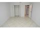 Bright bedroom features neutral paint, closet, and tile floors at 1400 Gandy N Blvd # 1705, St Petersburg, FL 33702
