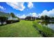 View of well-maintained lawns and community buildings, under a sunny blue sky with fluffy white clouds at 1400 Gandy N Blvd # 1705, St Petersburg, FL 33702