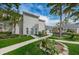 Inviting two-story building with manicured lawn, walkway, and flower bed near the entrance at 1400 Gandy N Blvd # 1705, St Petersburg, FL 33702