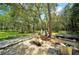 Well-maintained stainless steel barbeque and lush green trees in the community grill area at 1400 Gandy N Blvd # 1705, St Petersburg, FL 33702