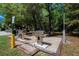 Community grill area with a well-maintained stainless steel barbeque and lush green trees in the background at 1400 Gandy N Blvd # 1705, St Petersburg, FL 33702