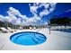 Close-up of community hot tub featuring crystal blue water and access steps at 1400 Gandy N Blvd # 1705, St Petersburg, FL 33702