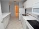 Efficient kitchen design with white appliances, an open breakfast bar and a view to the bathroom at 1400 Gandy N Blvd # 1705, St Petersburg, FL 33702